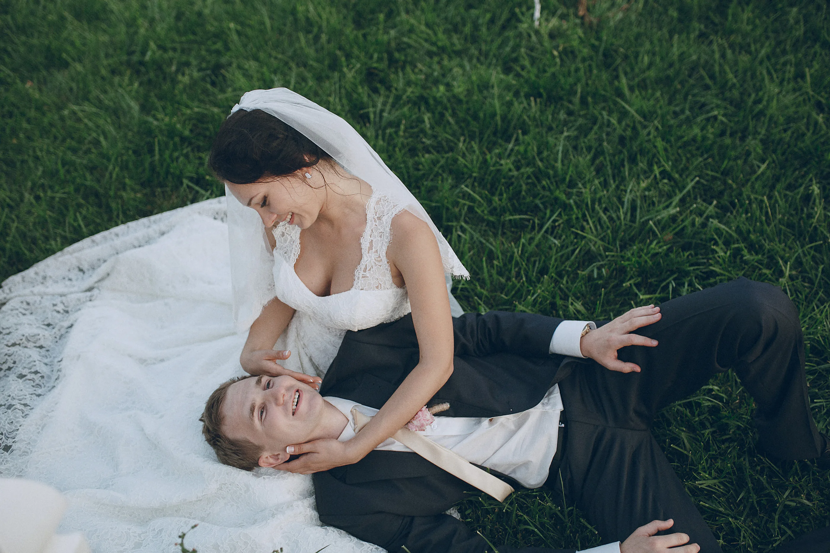 Newlyweds relaxing together on the grass