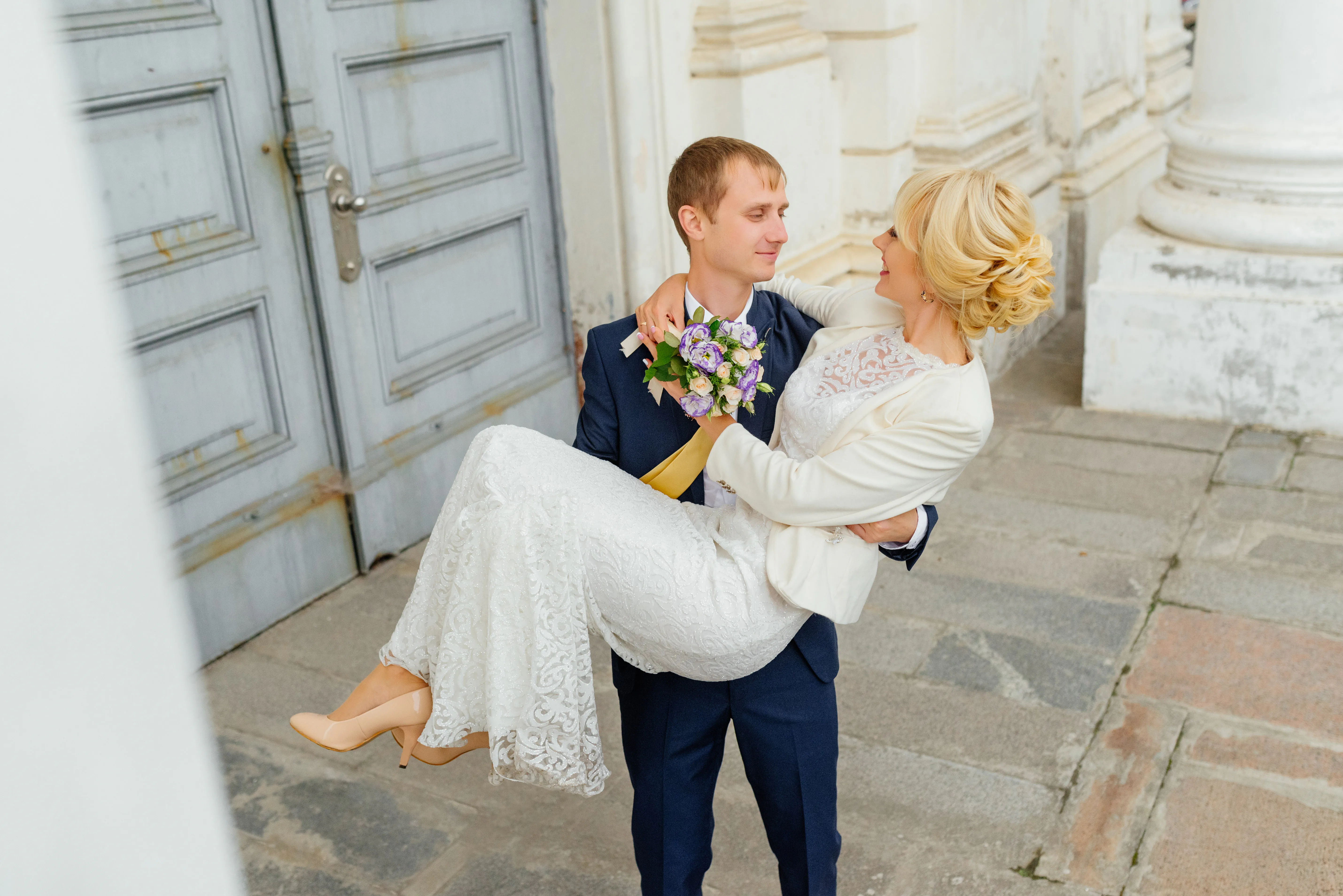 Bride and groom outside an elegant white venue